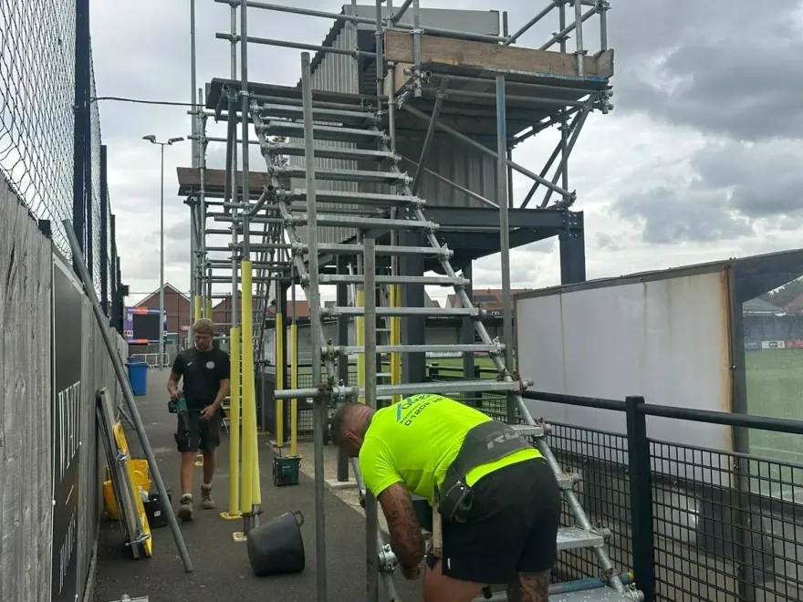 Up Top team installing a scaffold staircase at Wimborne Town FC