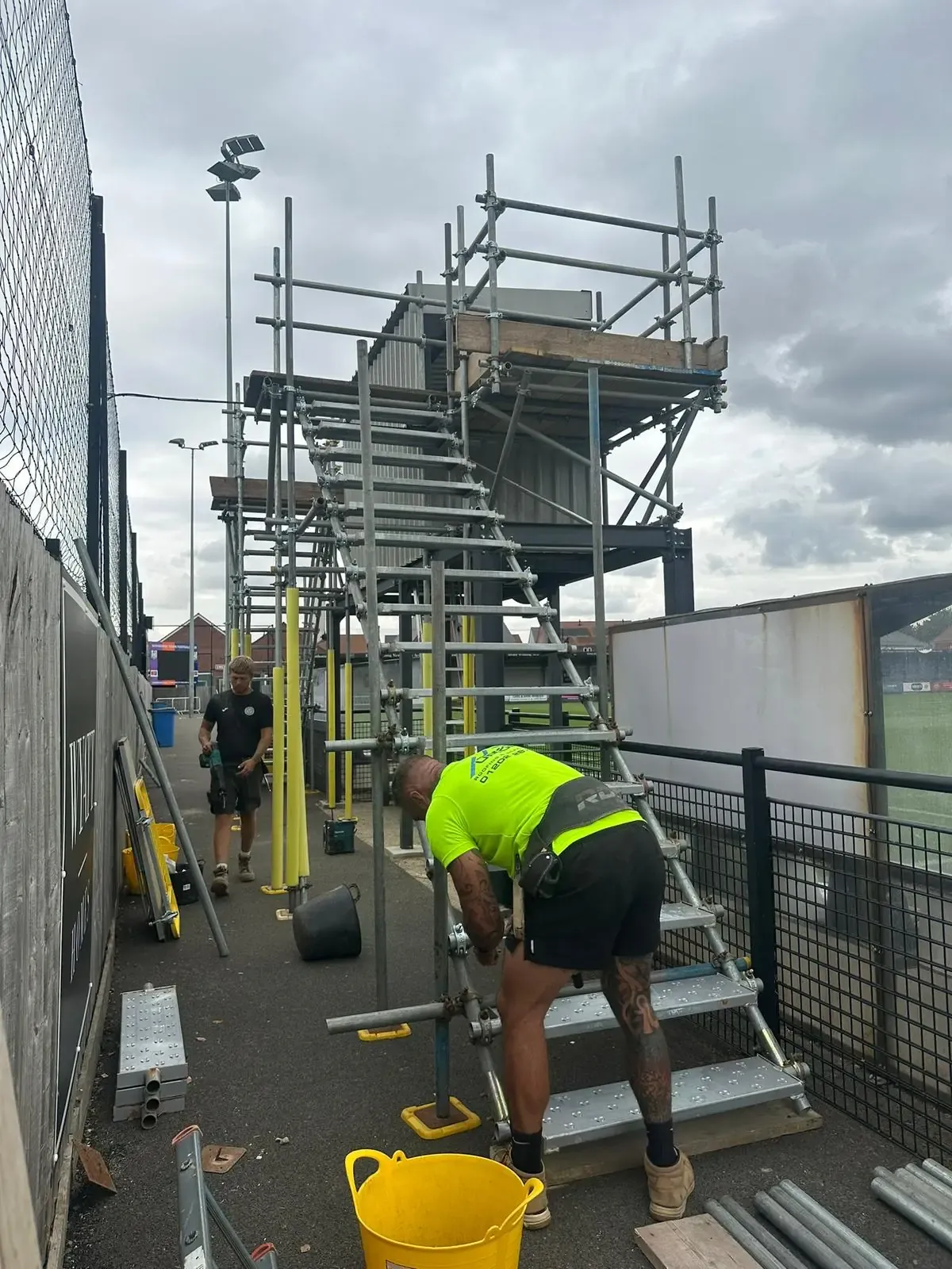 Up Top Scaffolding team installing a scaffold staircase to a viewing platform at Wimborne Town FC for AFC Bournemouth
