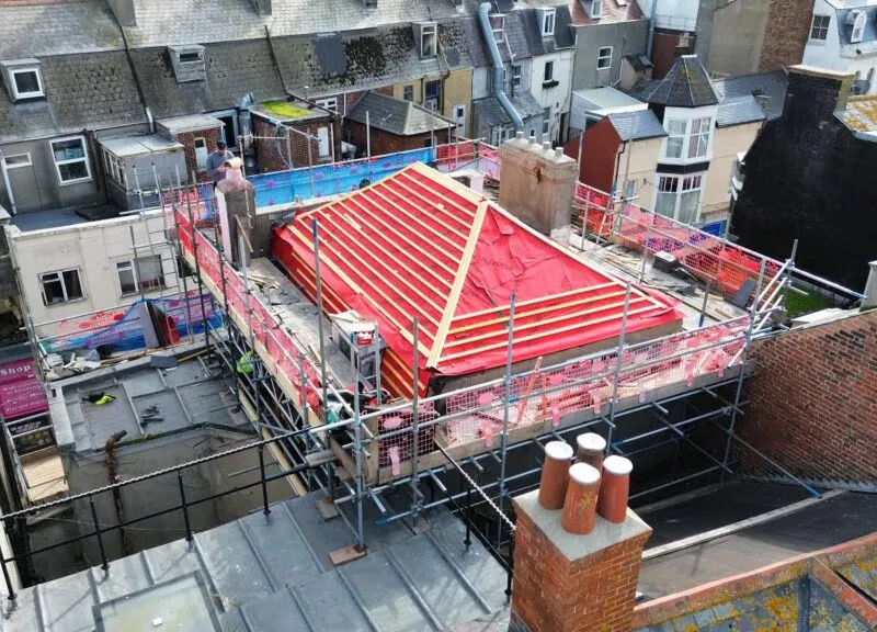 Close-up of new natural Spanish Mocha slates fitted on fully scaffolded Weymouth property.