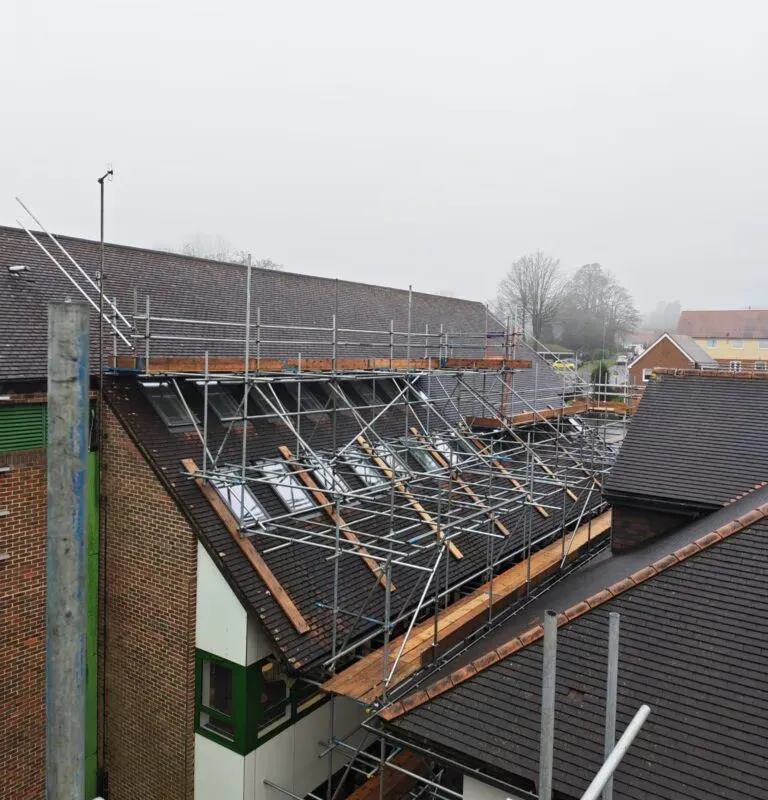 Up Top Scaffolding erecting bespoke roof-level scaffold structure at Crowborough Town Council for solar panel installation. Complex pitched roof scaffolding Crowborough, solar scaffolding East Sussex, scaffolding company Crowborough TN6, commercial scaffol