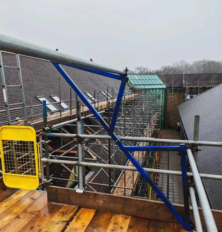 Detail view of bespoke scaffold platform on pitched roof at Crowborough Town Council solar panel project. Up Top Scaffolding complex roof scaffolding East Sussex. Solar scaffolding Crowborough, pitched roof scaffold TN6, scaffolding company East Sussex, Up