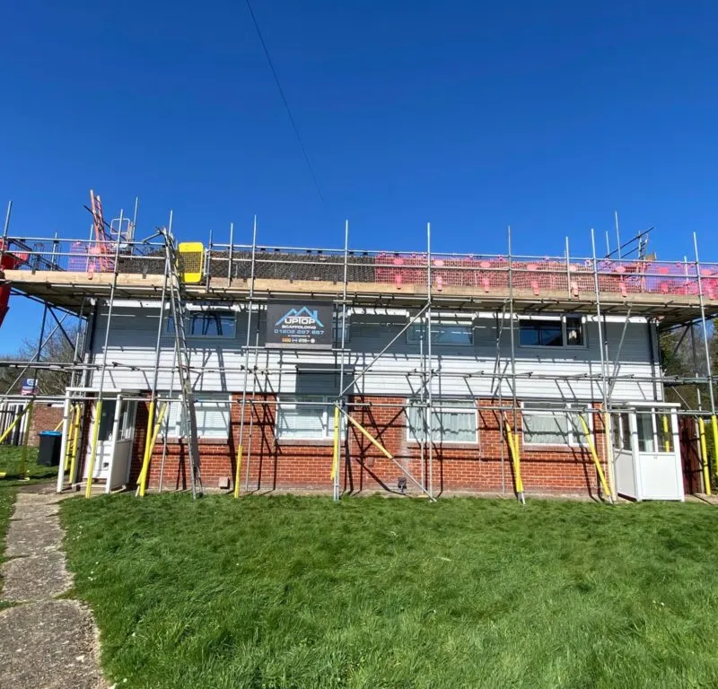 Complete scaffolding structure erected across full frontage of residential block in Christchurch Dorset for roof replacement works. Project undertaken by Up Top Scaffolding for Sovereign Network Group. All roofs brought up to building regulation standards.