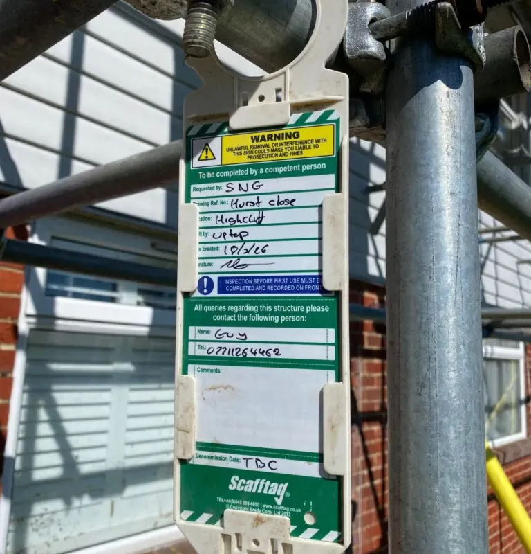Scafftag safety inspection tag displayed on scaffold structure at residential roof replacement project in Highcliff, Christchurch. Erected by Up Top Scaffolding for Sovereign Network Group. Scaffolding health and safety Christchurch, compliant scaffold Dor